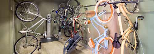 AMLI at Mueller bike repair room with bikes hanging vertically on the walls and a pump for filling wheels in the background