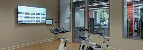 The yoga and spin room at AMLI 900 which has open free space in addition to a few specialized machines and a flat screen TV