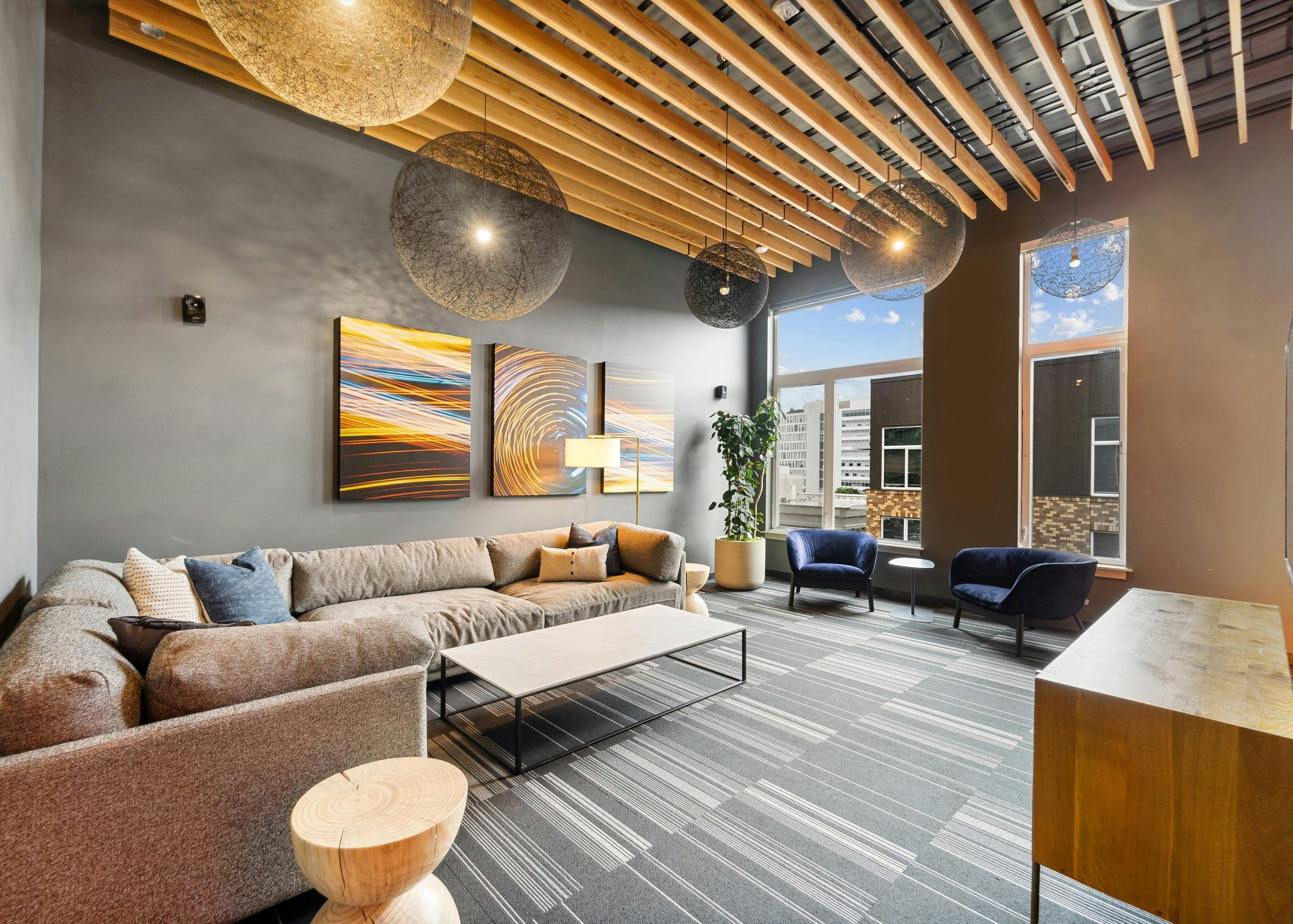 Interior view of rooftop lounge at AMLI South Lake union with couches and coffee table and vibrant wall paintings