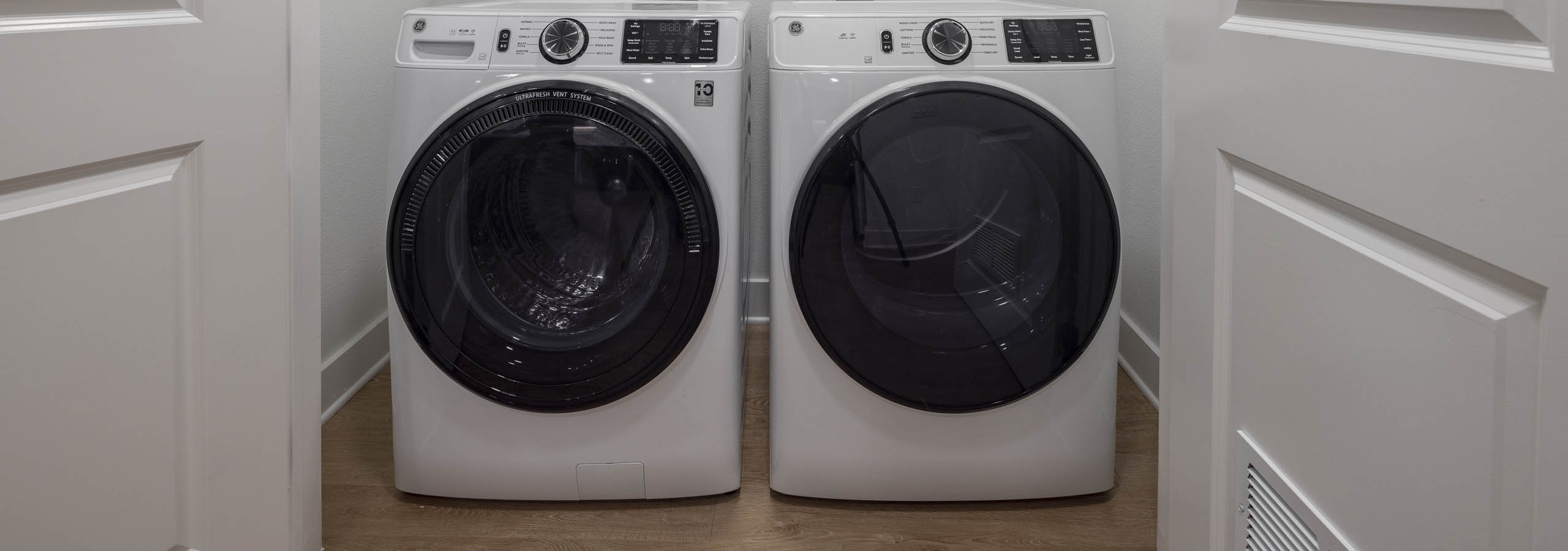 Close up interior view of modern in unit laundry machines tucked away in spacious AMLI Branch Park apartment closet