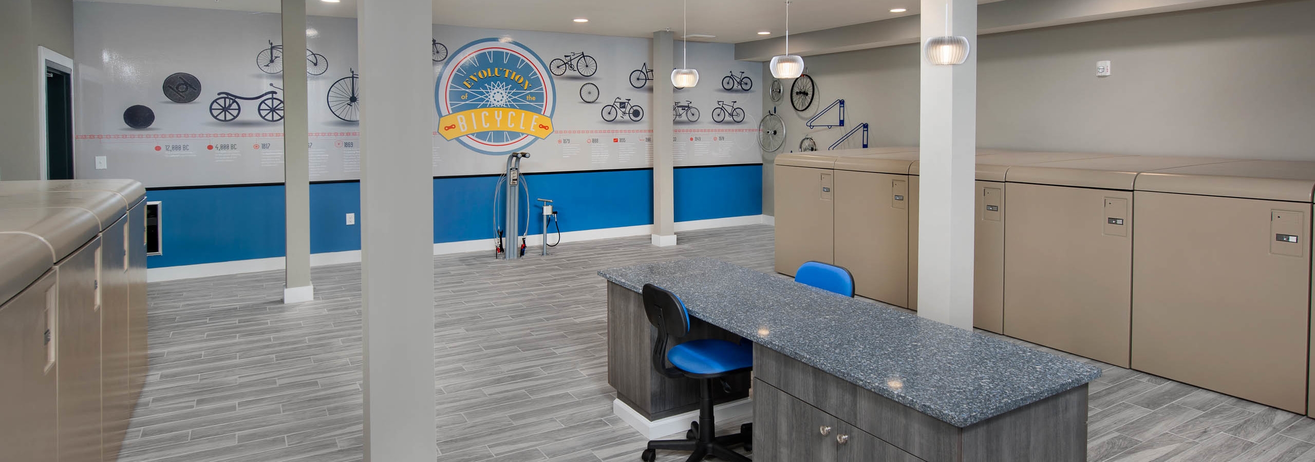 AMLI Piedmont Heights bike repair room with storage lockers and a large table set up for repair needs with air pump for tires