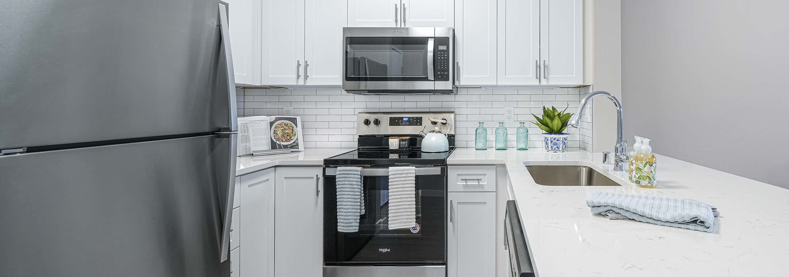 Kitchen with stainless steel appliances and tile backsplash