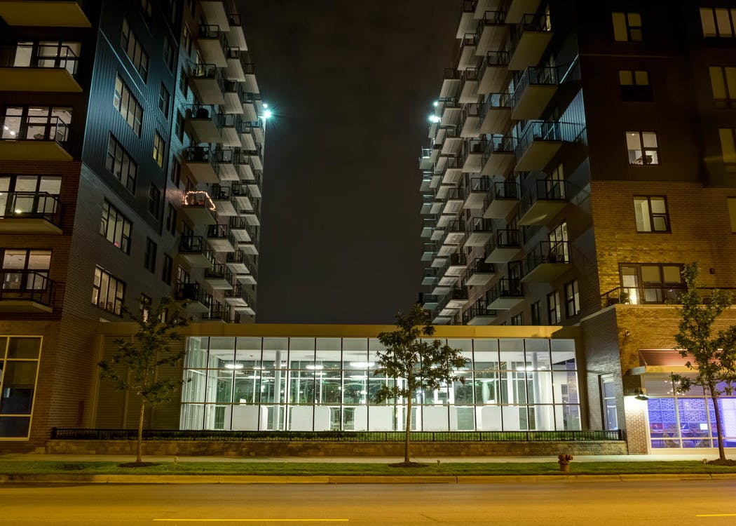 Exterior view of the AMLI Lofts apartment community building facade brightly lit up at night time in the city of Chicago