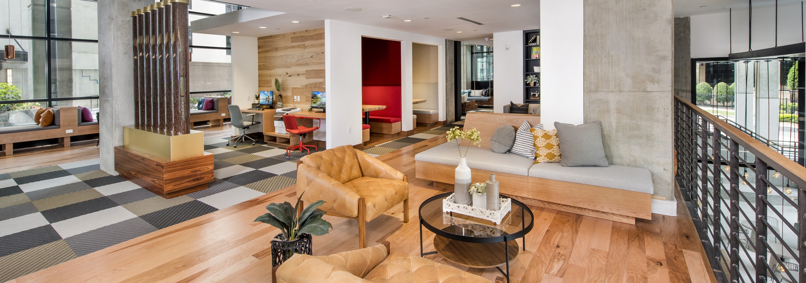 Interior view of the upstairs of AMLI Lenox clubhouse with wood floors and computer work stations and multiple seating areas