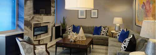 Resident lounge at AMLI Deerfield with a marble fireplace and large TV with various couch and chair seating options