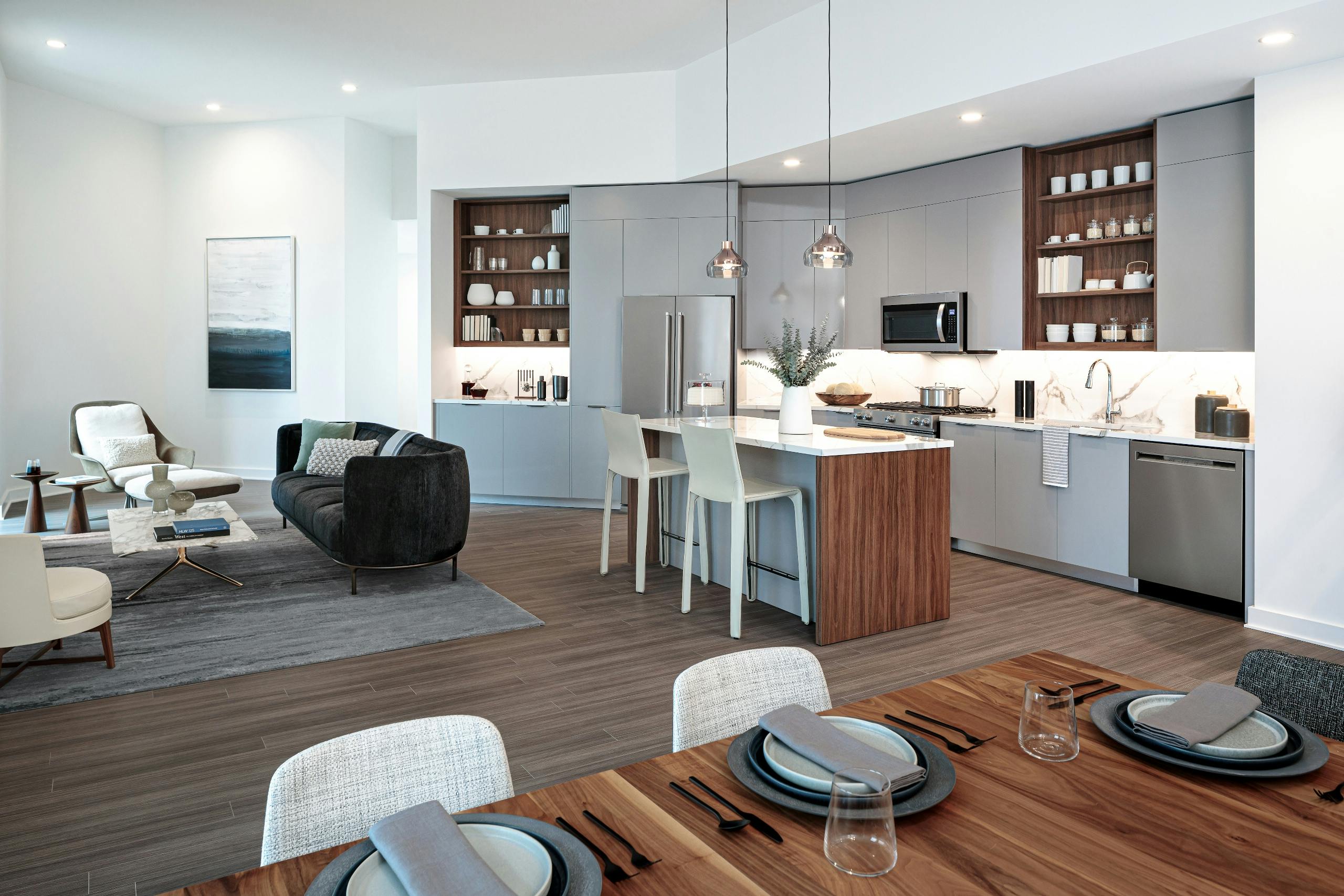 Interior view of AMLI Fountain Place apartment kitchen with island and stainless steel appliances.