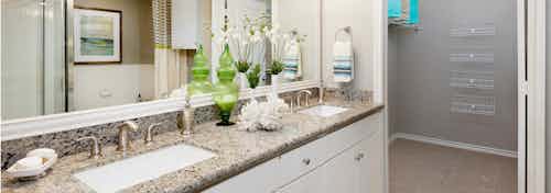 AMLI Memorial Heights apartment bathroom with granite double vanity and white cabinets and view into walk-in closet