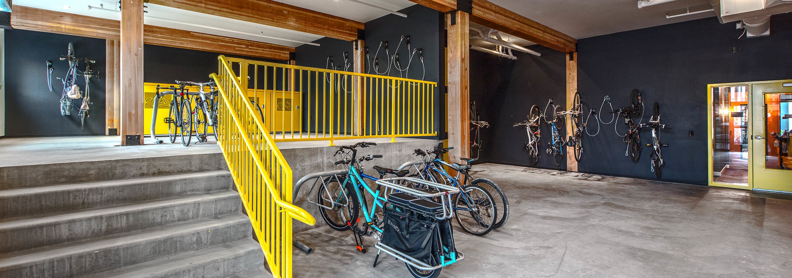 Interior bike room of AMLI Wallingford with bike storage tools storage lockers with large floor to ceiling windows facing the sidewalk