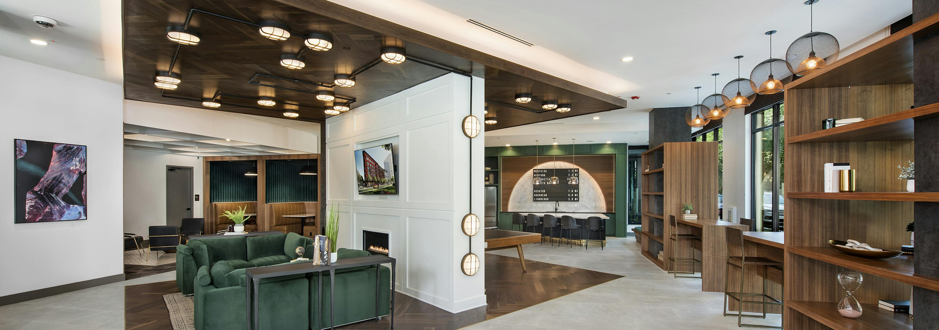 Clubhouse at AMLI Flatiron apartments with central seating area with wood ceiling and wood inset floor and open wood shelves
