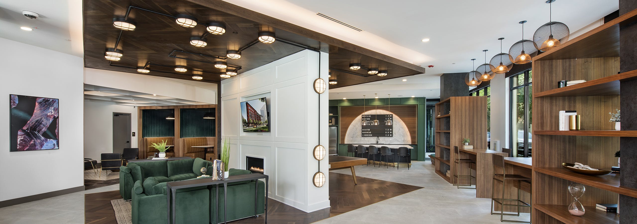 Clubhouse at AMLI Flatiron apartments with central seating area with wood ceiling and wood inset floor and open wood shelves