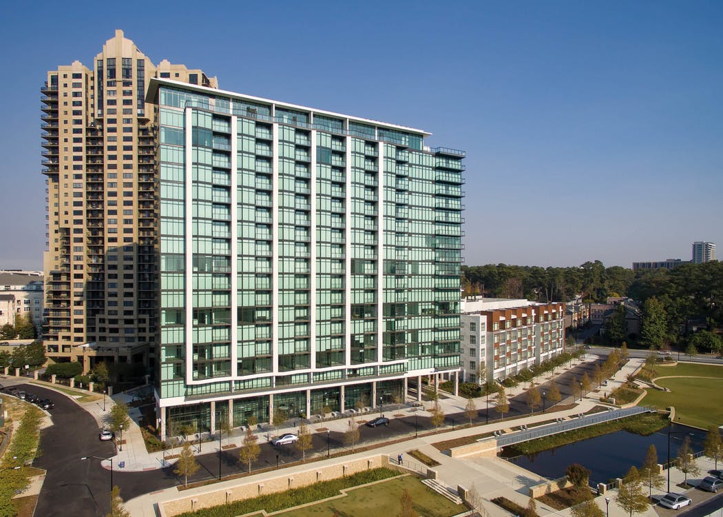 Daytime exterior image of AMLI 3464 luxury apartment building with its 19-story high rise in the heart of Buckhead
