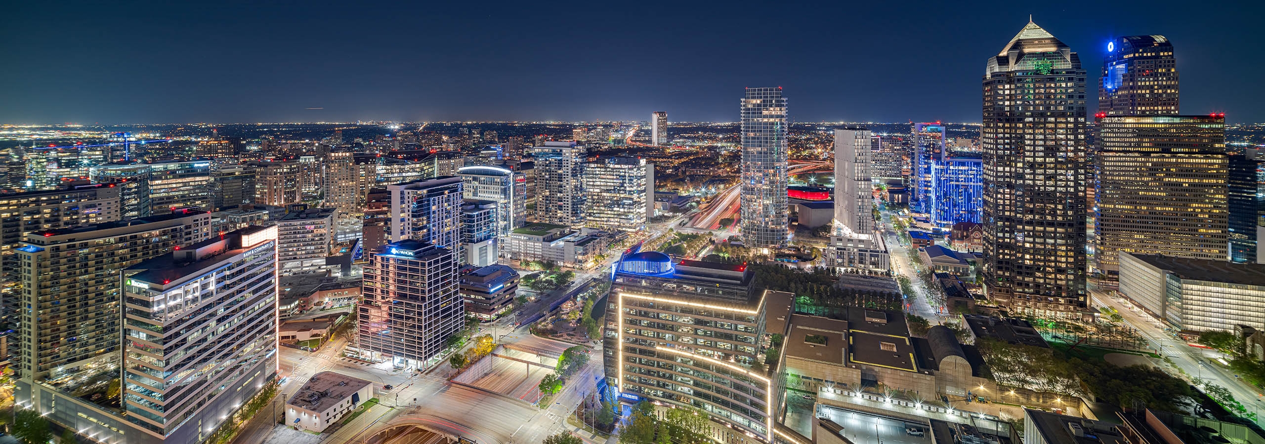 Night view of downtown Dallas skyline with hundreds of colorfully lit up buildings from AMLI Fountain Place apartment building