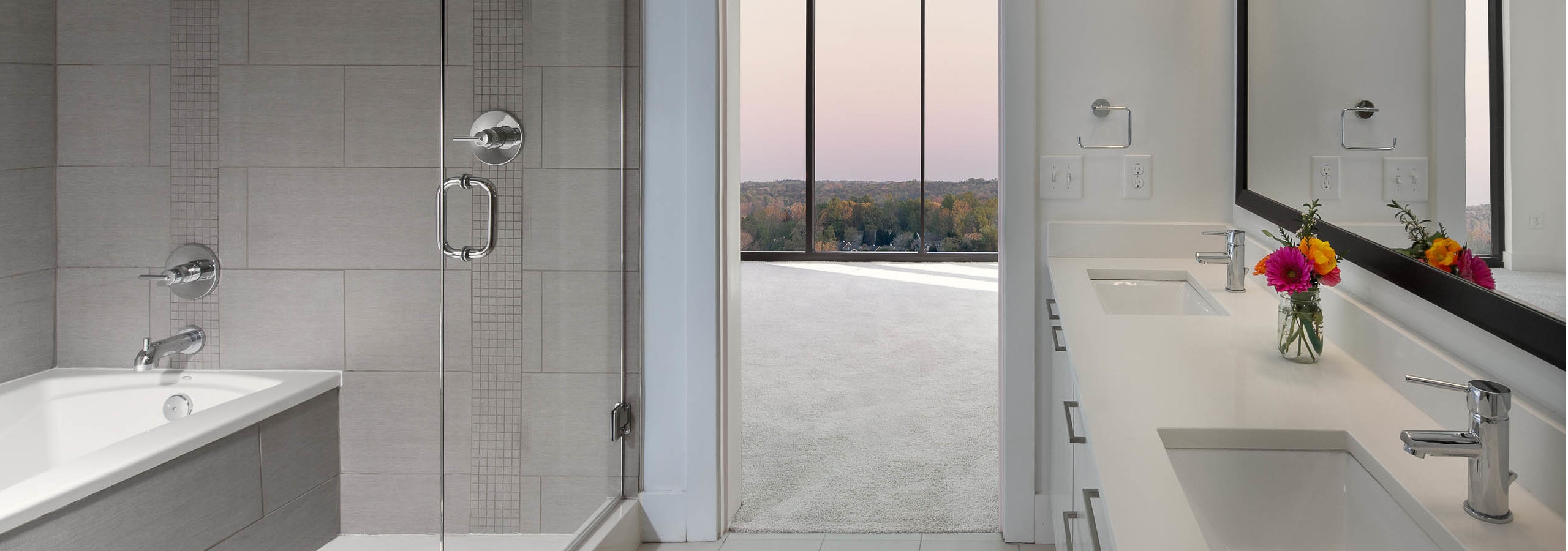 AMLI 3464 bathroom with double vanity sinks across from a glass door which opens up to a standing shower and separate bathtub