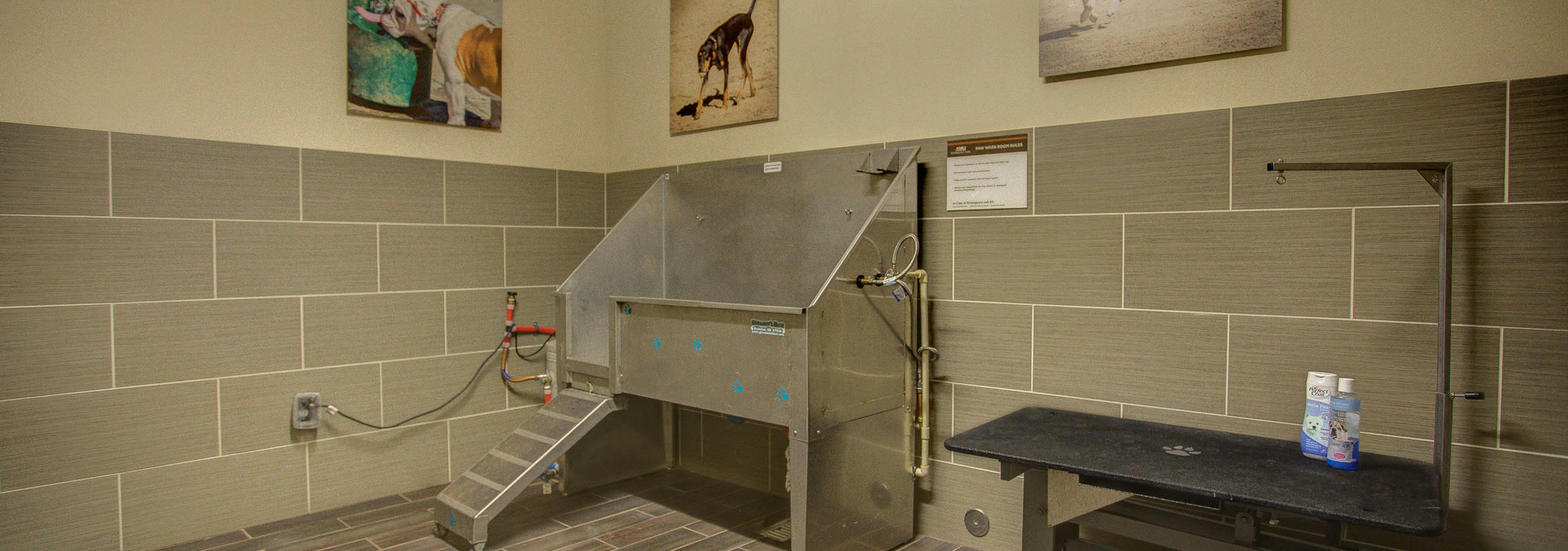 Pet washing area at AMLI Riverfront Park apartments with view of the wash tub and grooming stand as well as pet photography