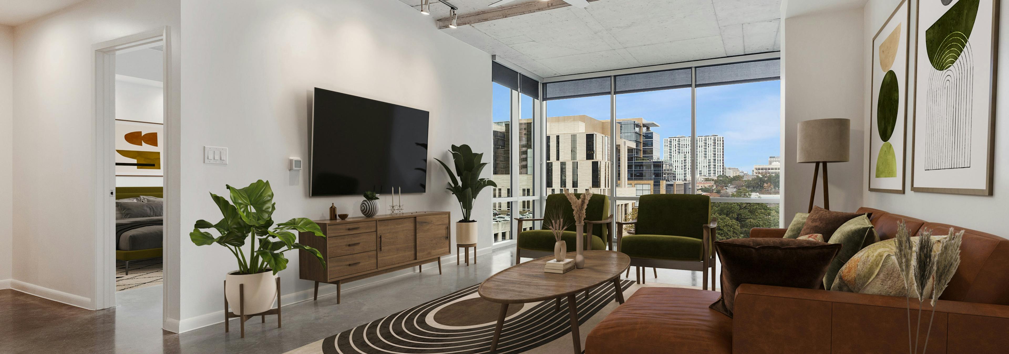 AMLI on 2nd living room with brown couch and 2 green chairs facing big screen TV with city view through a wall of windows