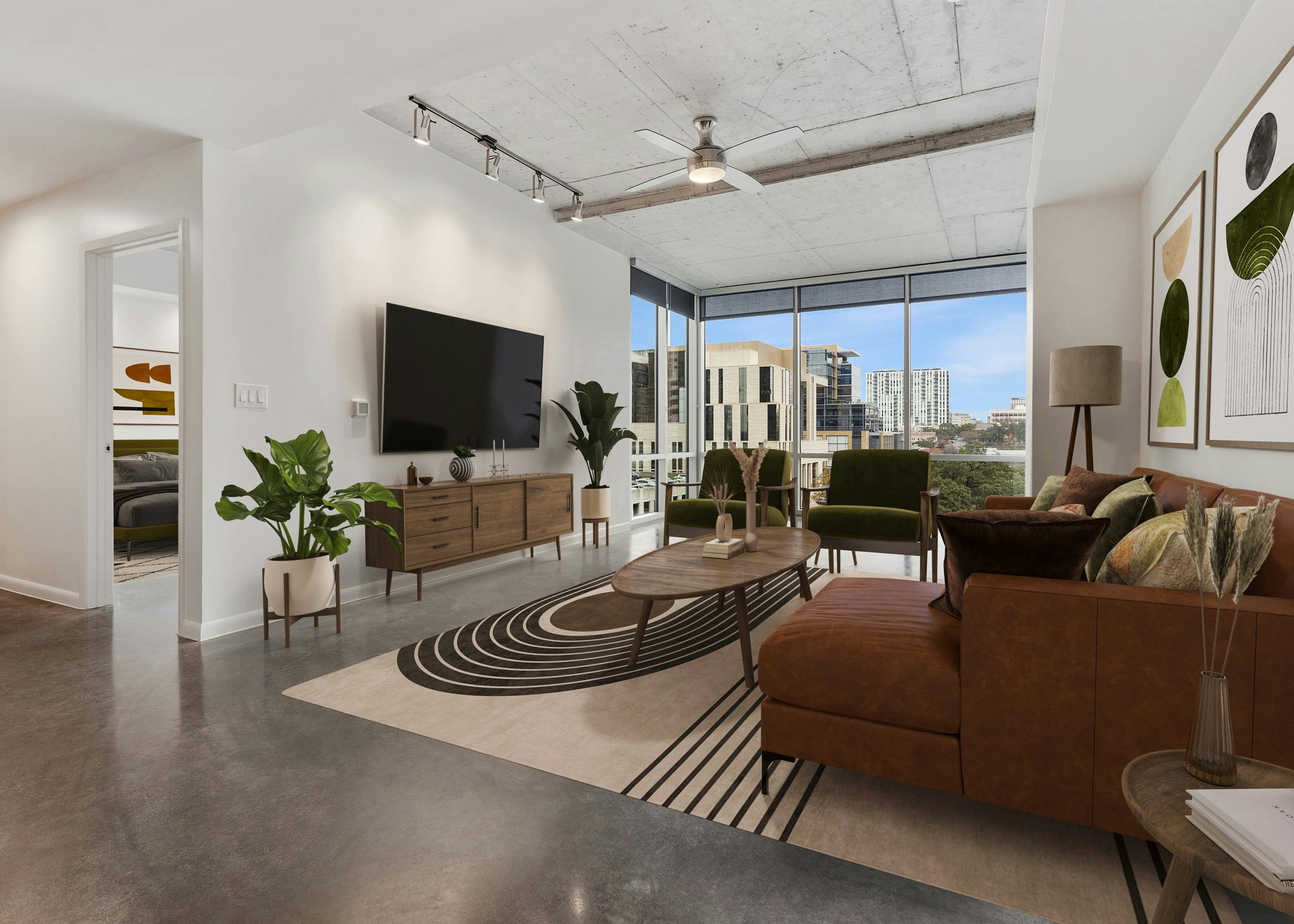 AMLI on 2nd living room with brown couch and 2 green chairs facing big screen TV with city view through a wall of windows