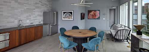 Interior view of AMLI Park Broadway rooftop lounge with catering kitchen and a variety of seating and flat screen TV