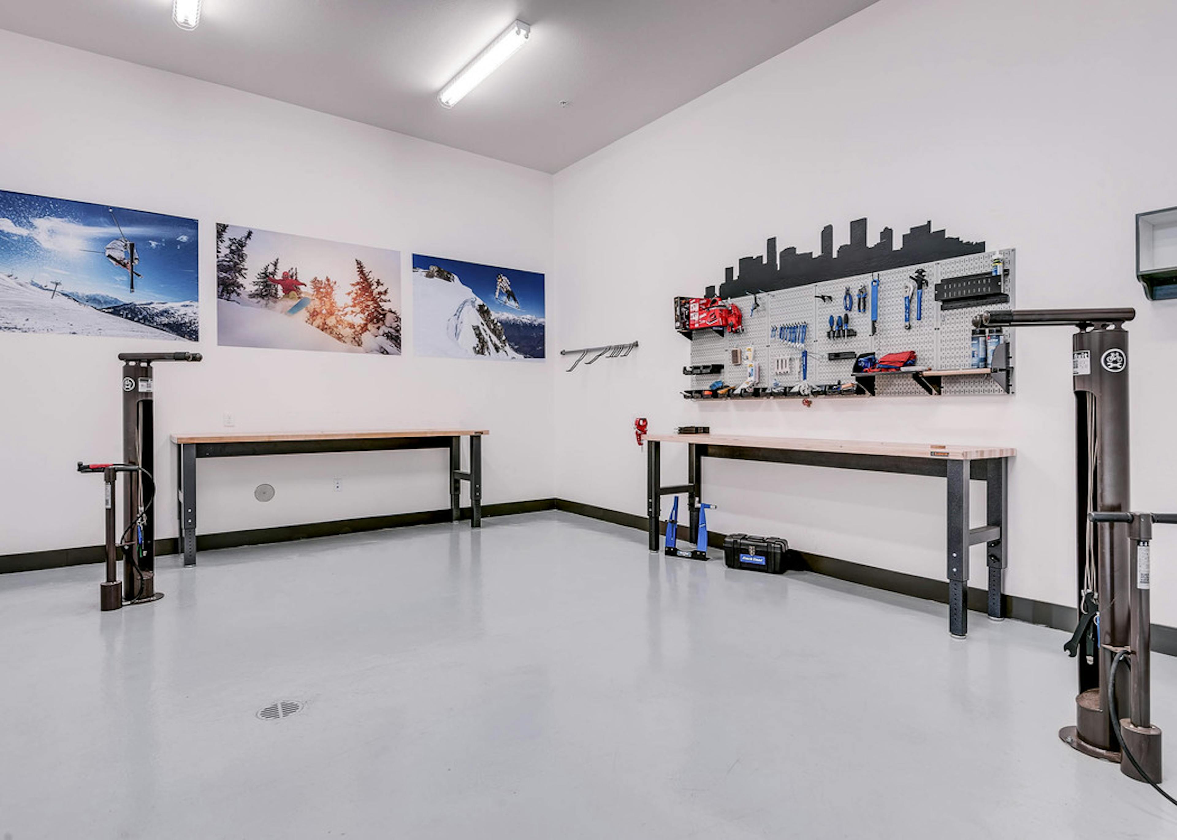 Interior bike repair room area at AMLI Cherry Creek apartments with view of work station table with tools and photography 