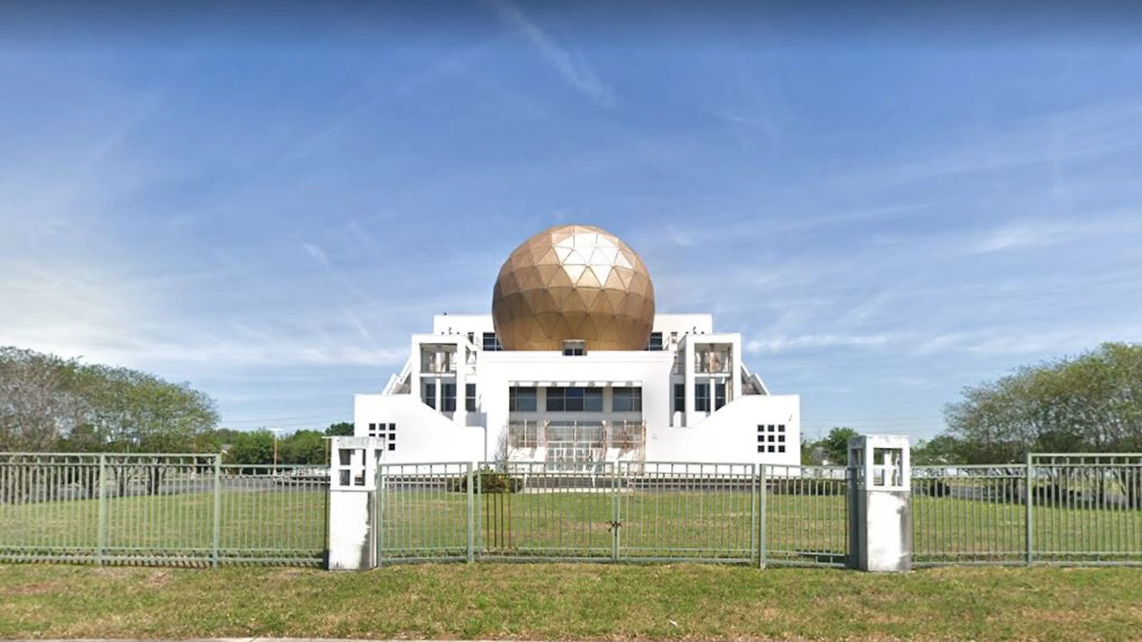 Screenshot of a Google Maps' view of a white temple with a massive golden orb in the center.