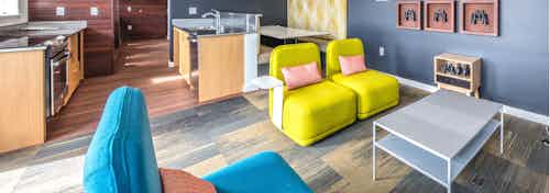 Take in the views of downtown Seattle from our rooftop lounge at AMLI Wallingford with a fully equipped kitchen colorful seating area