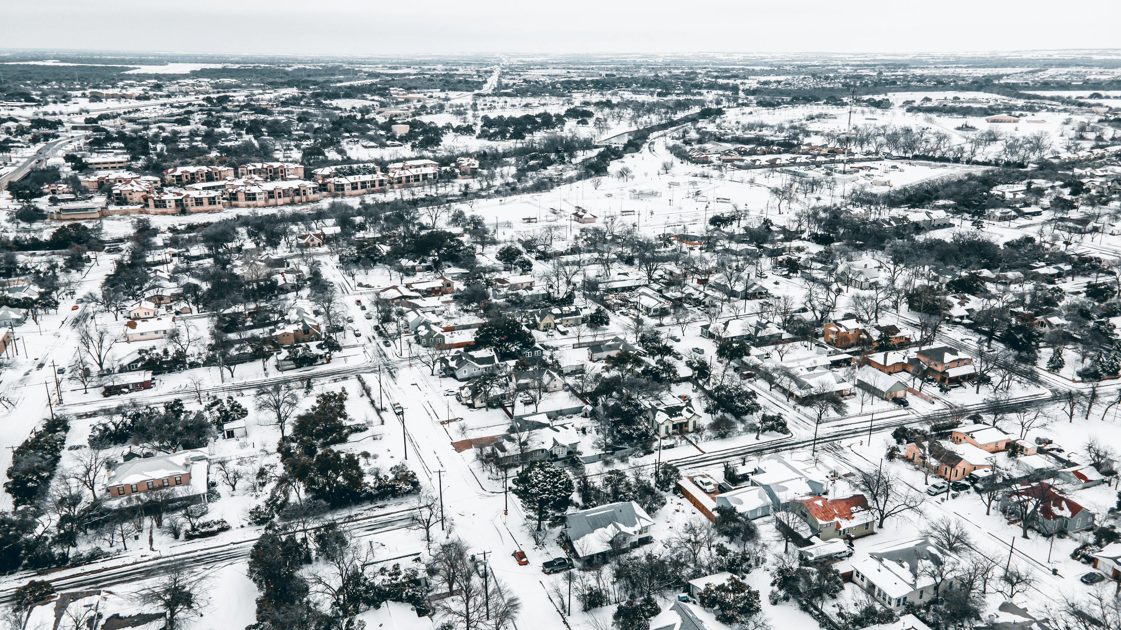 An aerial view of a small town covered in snow