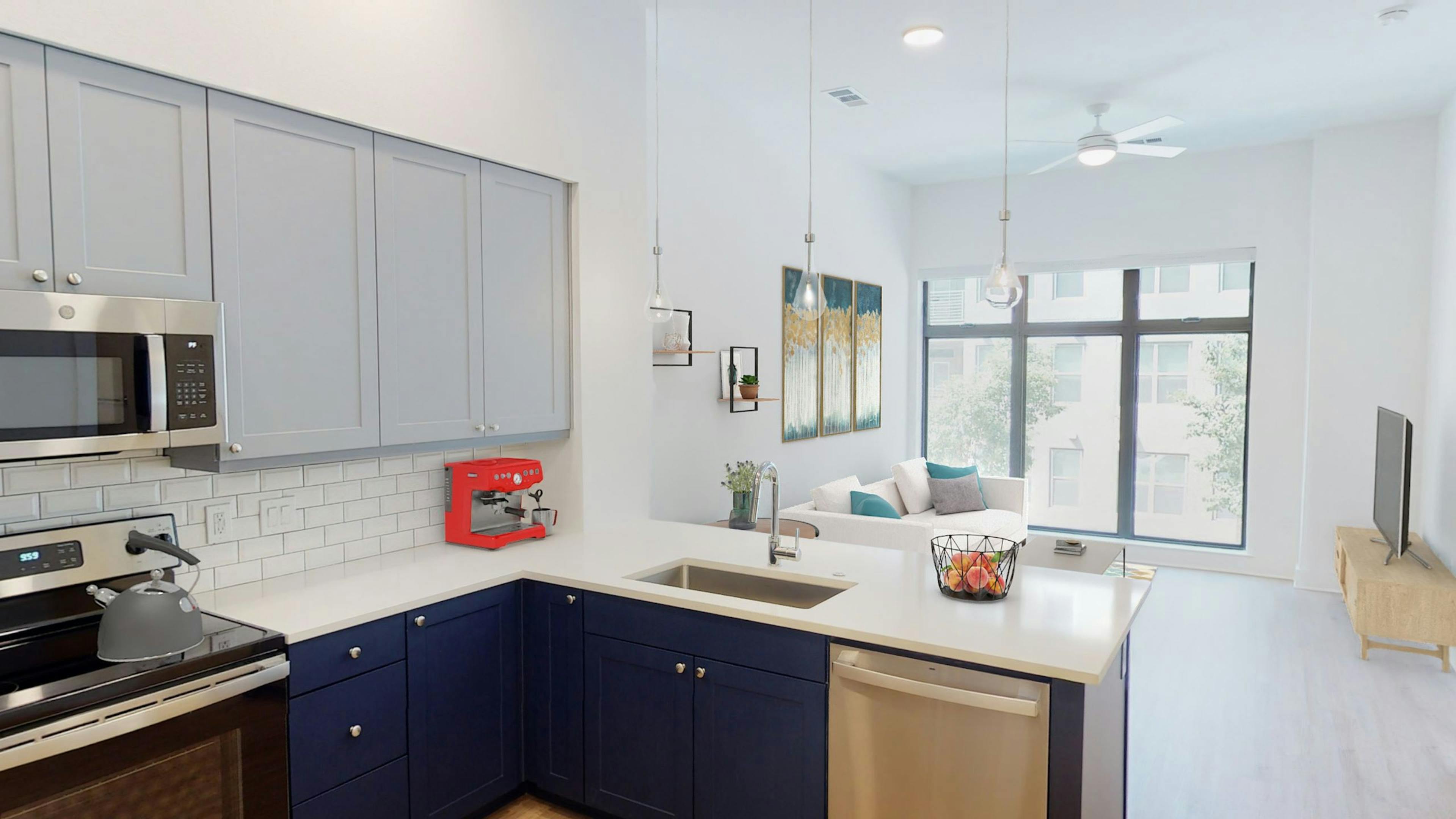 AMLI Branch Park kitchen with gray cabinets above and blue cabinets below overlooking living room with large window