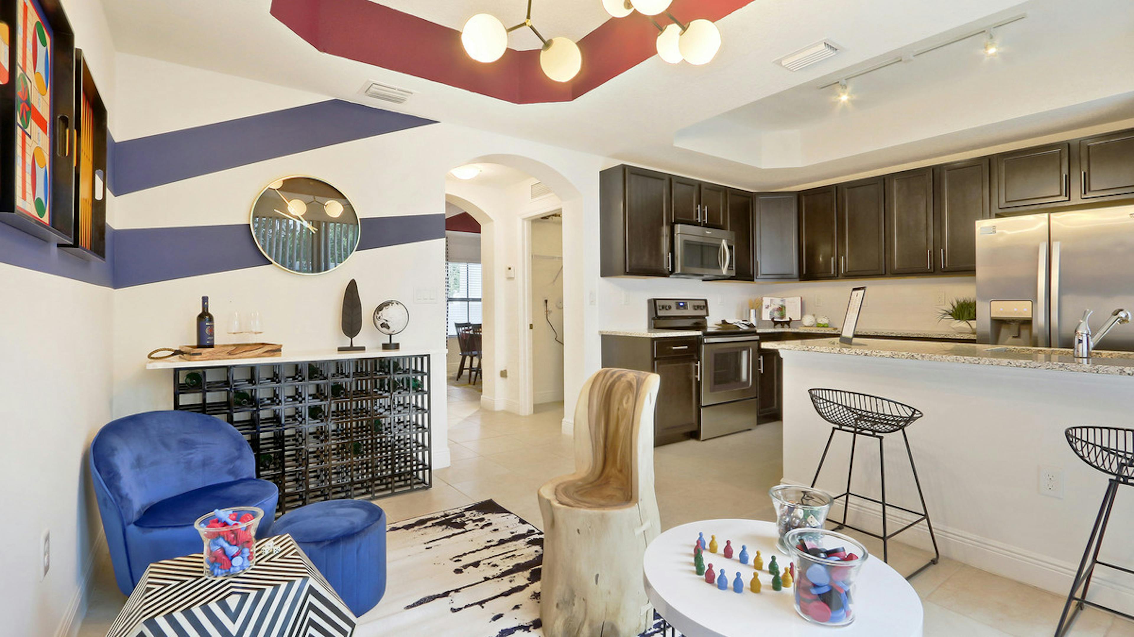 Interior view of AMLI Toscana Place Townhouse dining area, with island kitchen and stainless steel appliances