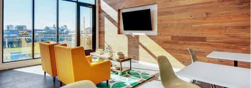 Interior of skybox suite overlooking Dr Pepper Ballpark at AMLI Frisco Crossing apartment building with big screen TV