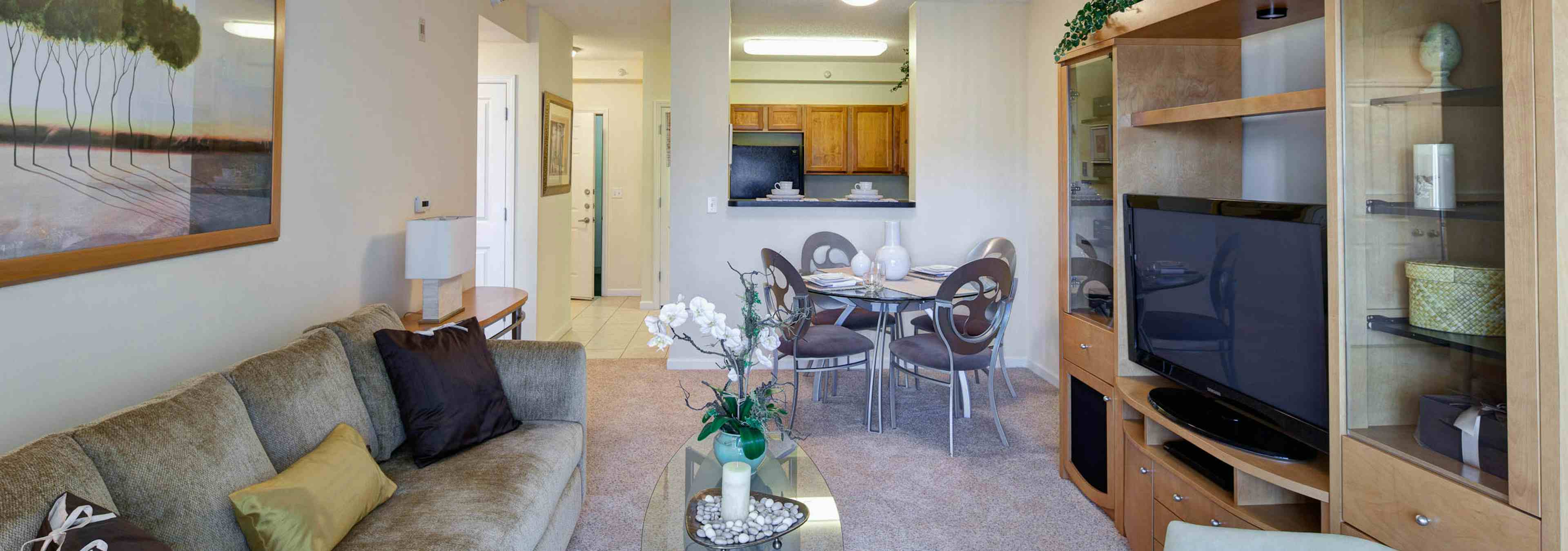 Interior view from a living room with neutral decor at AMLI at Seven Bridges with kitchen visible in the background