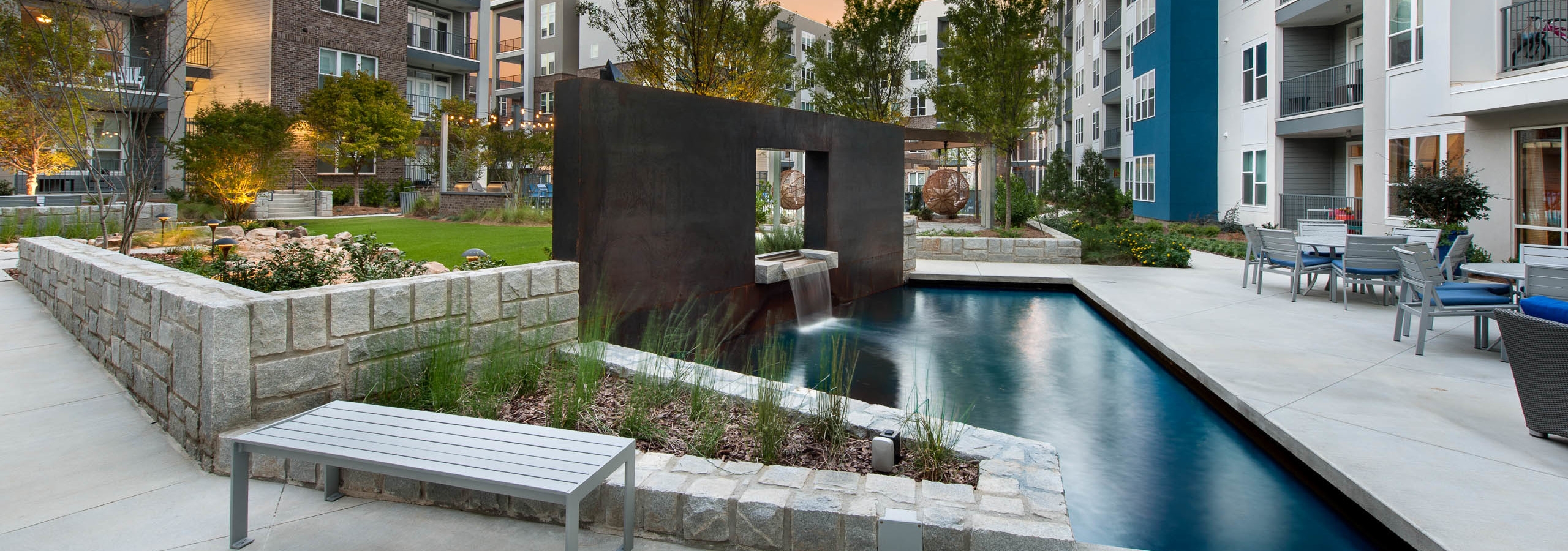 Exterior view of an outdoor fountain in the middle of AMLI Piedmont Heights apartment courtyard in between its buildings