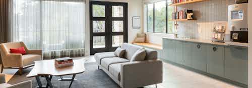 Interior view of AMLI Covered Bridge resident clubhouse with comfortable seating and a java bar with Starbucks coffee