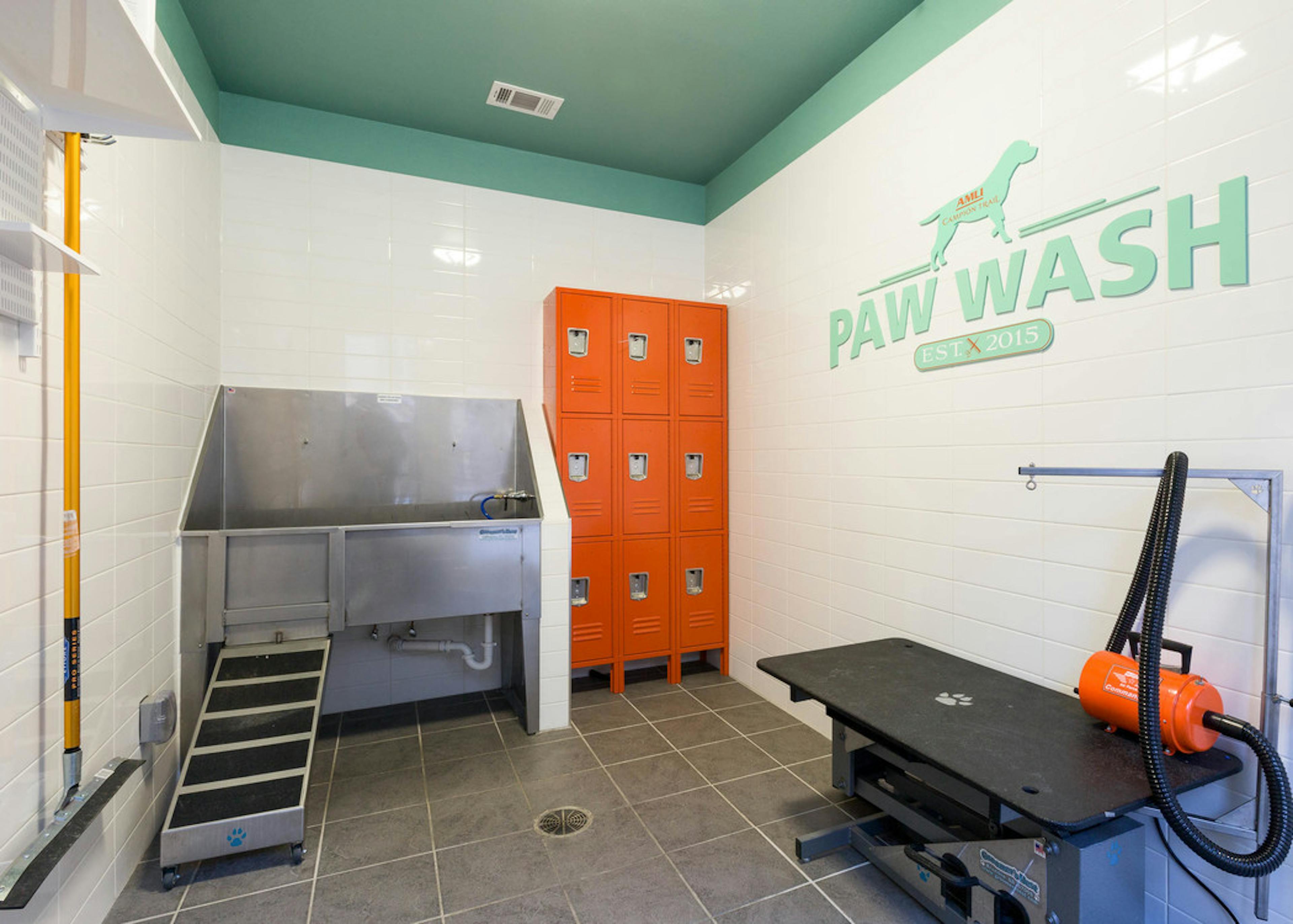  Interior of paw wash at AMLI Campion Trail apartment building with stainless tub and lockers and grooming stand and dryer