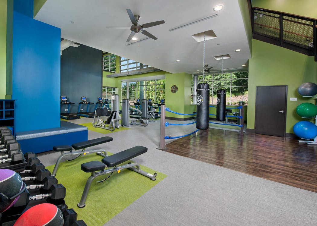 Two-story fully equipped fitness center at AMLI Piedmont Heights with treadmills as well as cardio and strength machines
