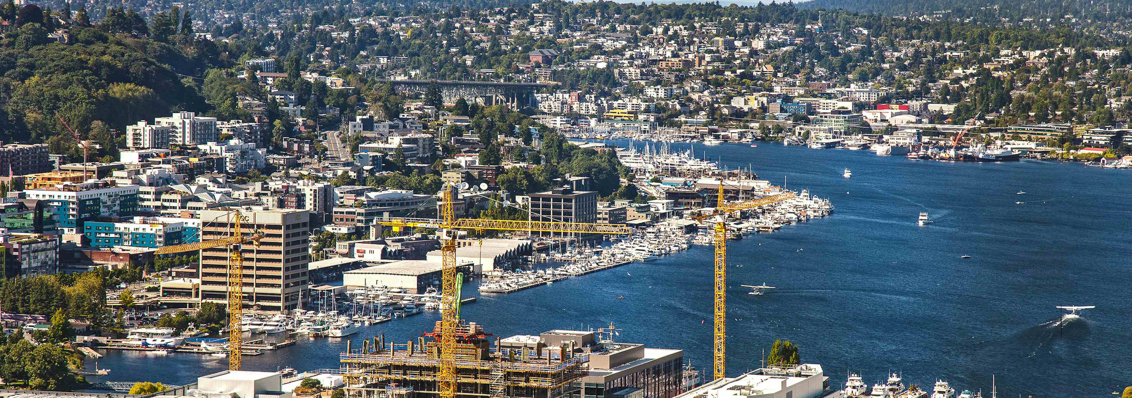 Blue Sky sunny Seattle Day Exterior view from AMLI Arc of Lake Union Wallingford and Westlake Ave from the 41st floor 