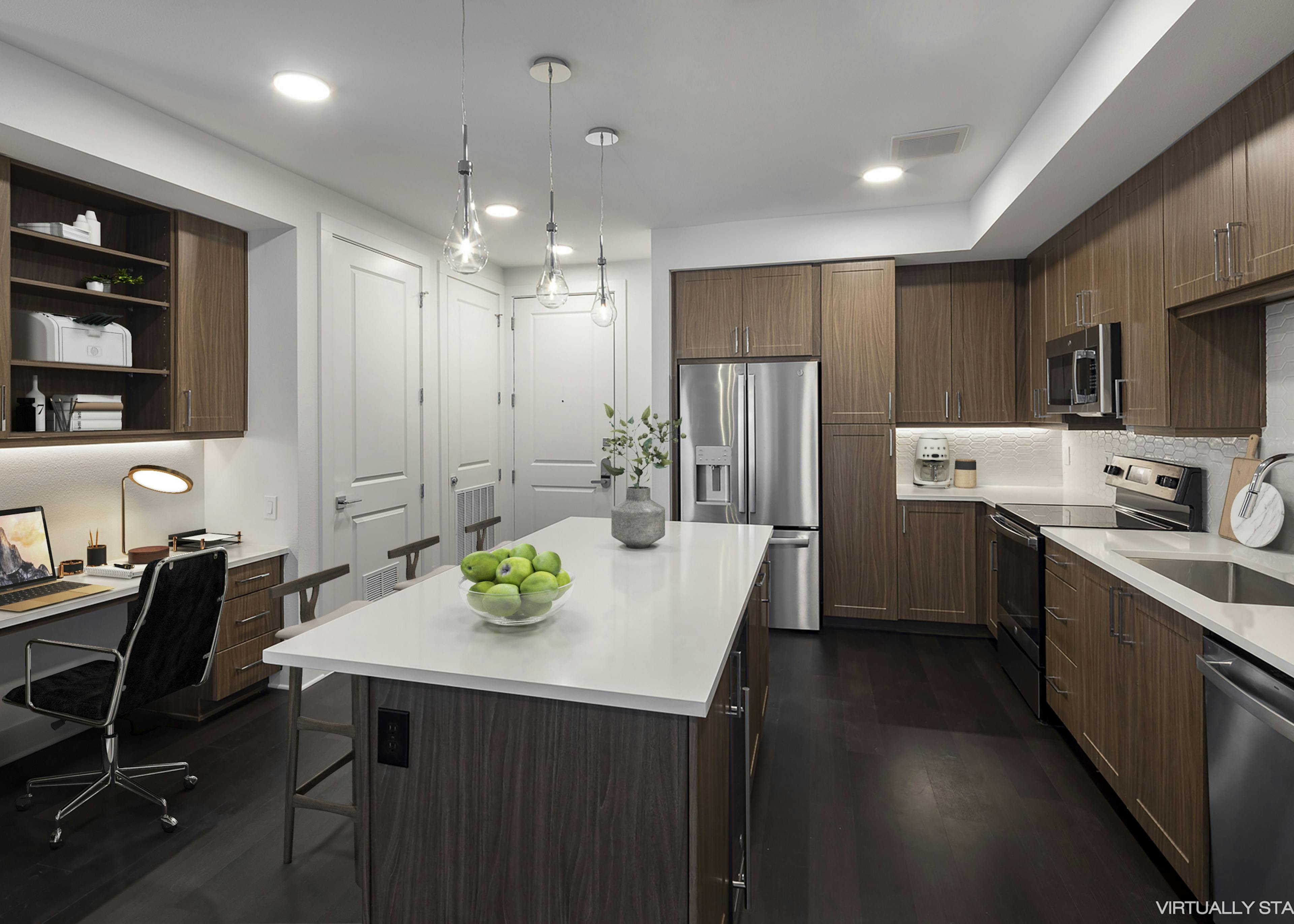 AMLI Branch Park spacious apartment kitchen with brown modern cabinetry and sleek white countertops and built-in desk and shelves