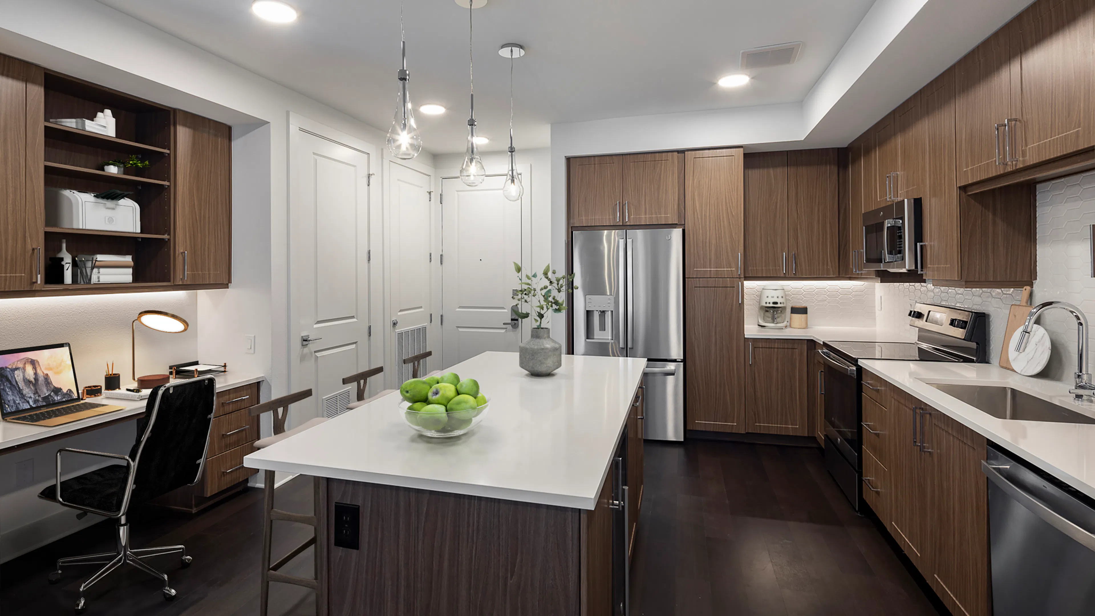 AMLI Branch Park spacious apartment kitchen with brown modern cabinetry and sleek white countertops and built-in desk and shelves