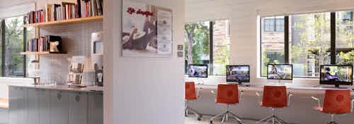 AMLI Covered Bridge resident cyber zone and business center with computers and red swivel chairs