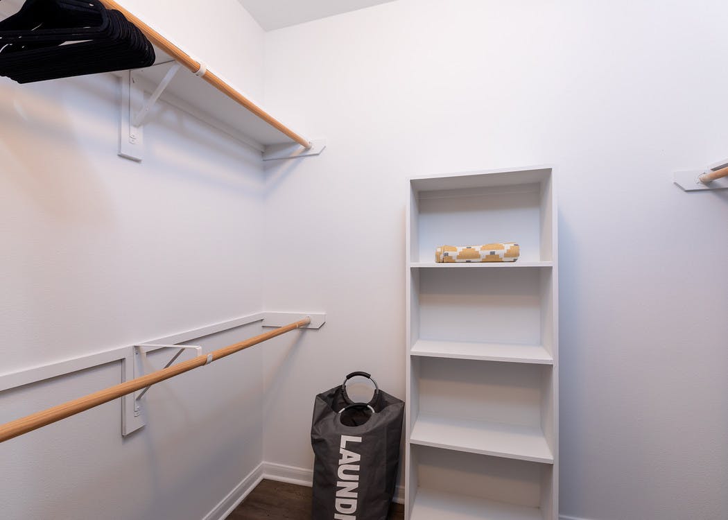 AMLI 300 apartment expansive walk-in closet with a yellow towel and laundry bag