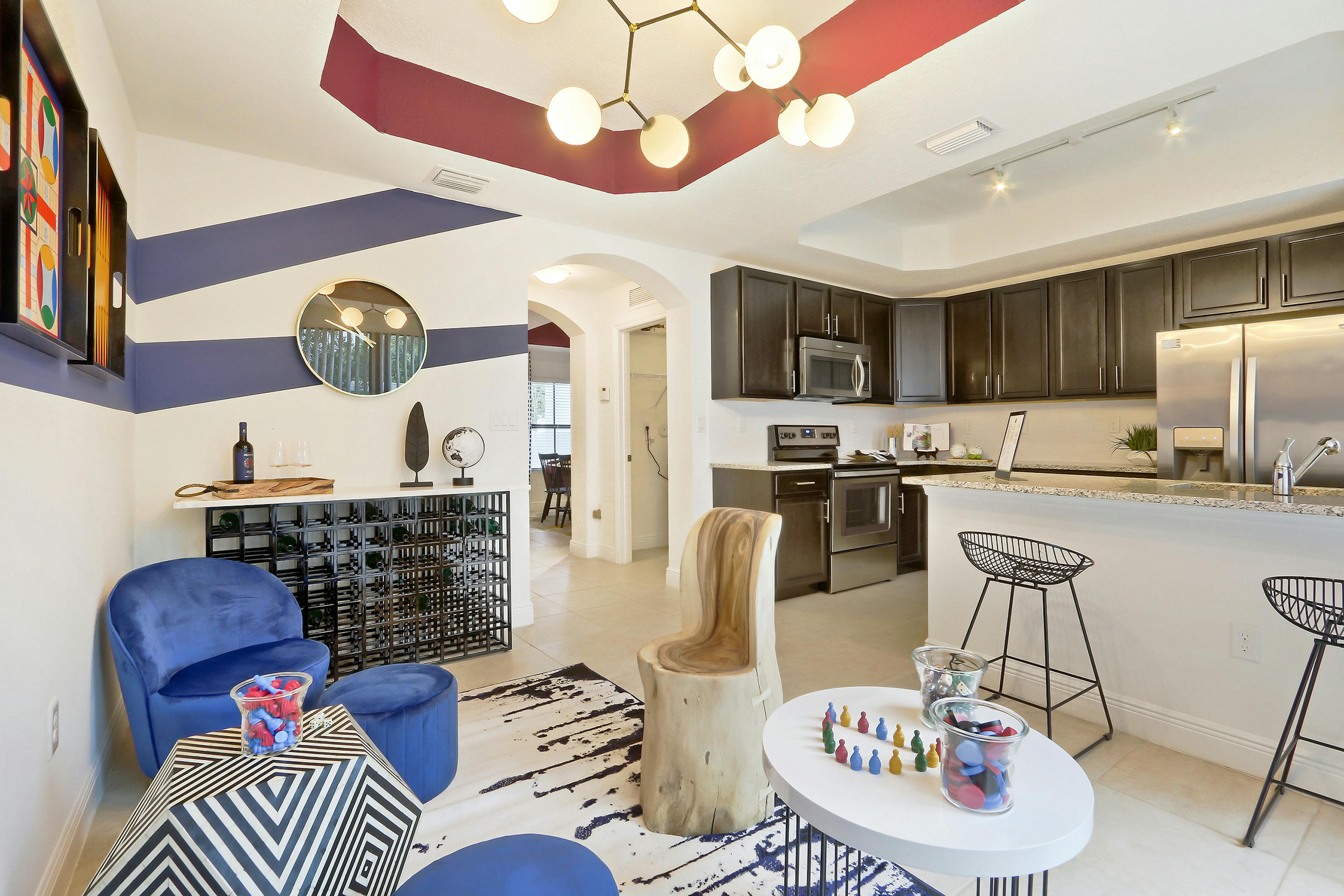 AMLI Toscana Place Townhouse dining area, island kitchen with stools, granite counters and stainless steel appliances