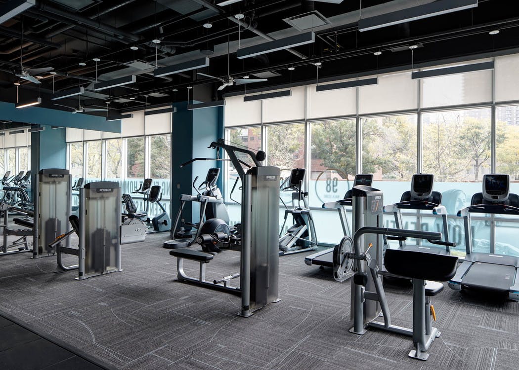 Interior view of the fitness center at AMLI Lofts featuring treadmills and elliptical machines as well as other equipment
