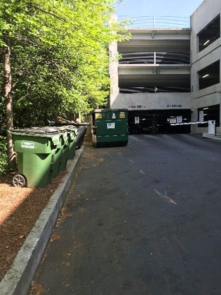 Outdoor recycling area outside of a parking garage at an AMLI apartment community