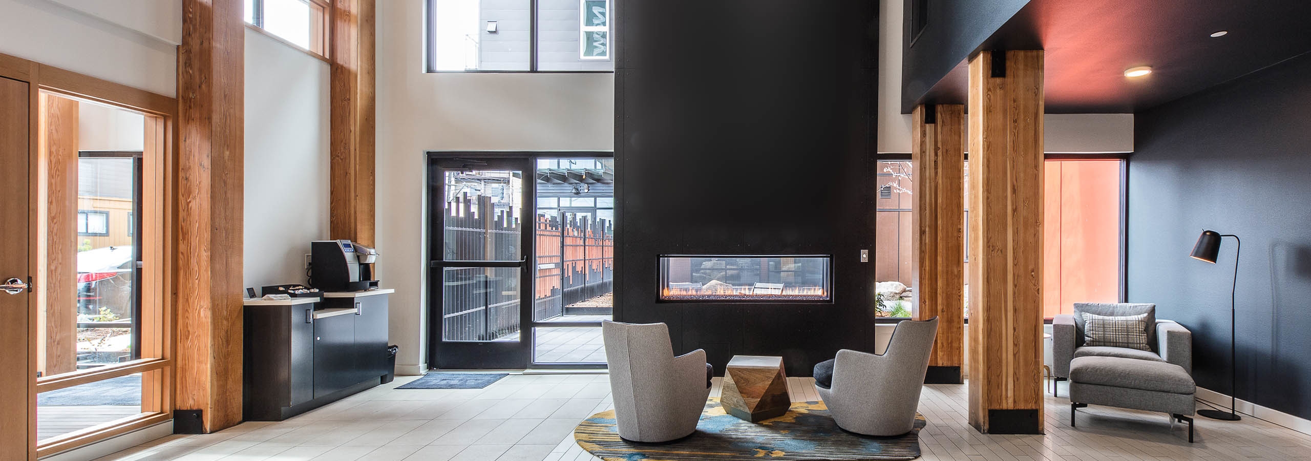 Interior resident area at AMLI Wallingford with coffee maker fireplace and comfortable seating with access to courtyard