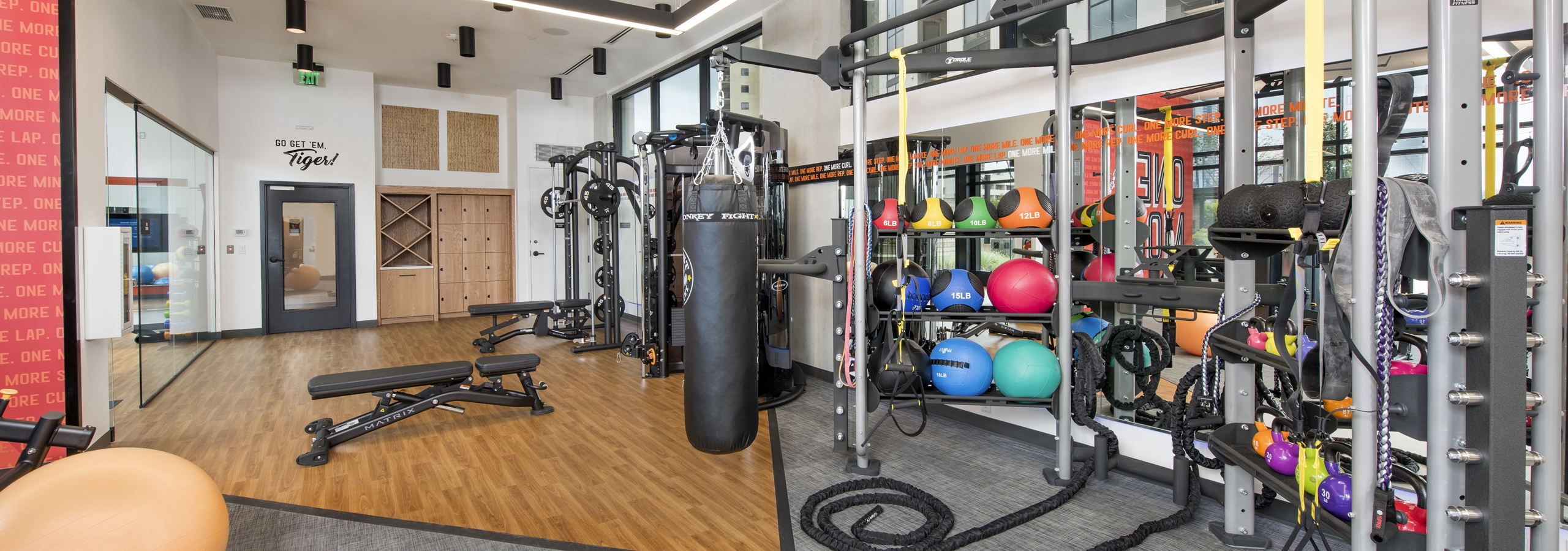 Close up view of equipment at AMLI Lenox fitness center with multiple exercise machines and brightly colored balls