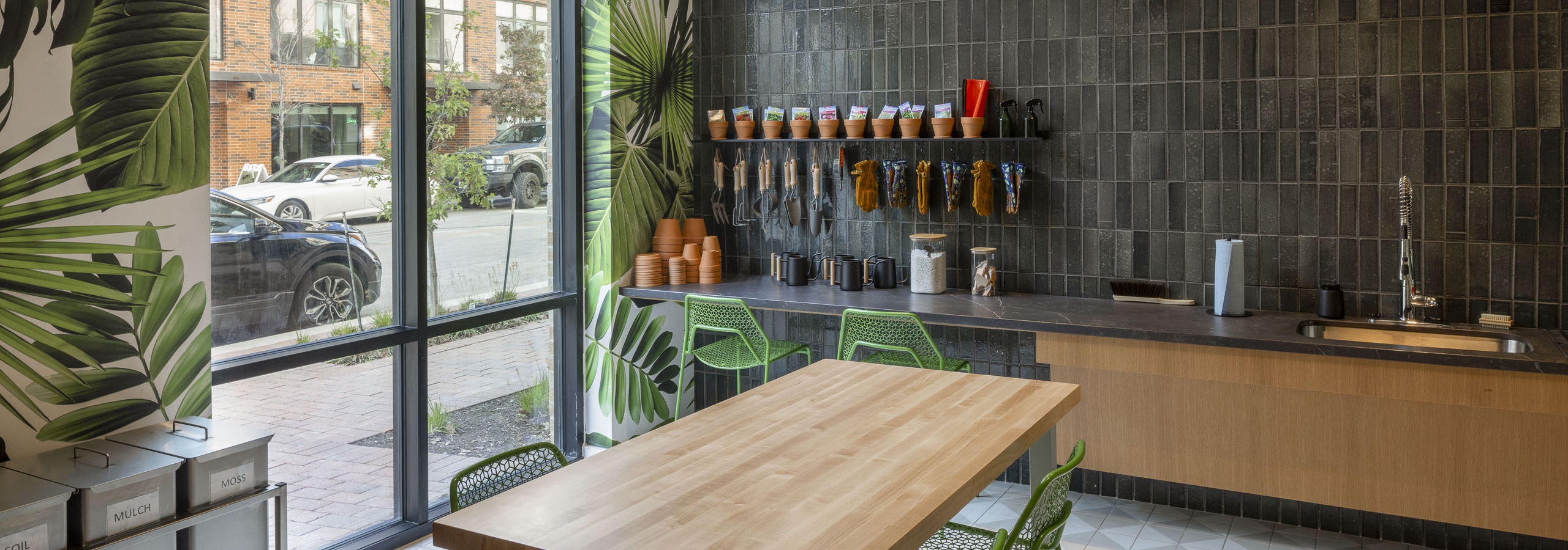 Garden room at AMLI Branch Park apartments featuring soil and mulch containers and a wide range of plant tools