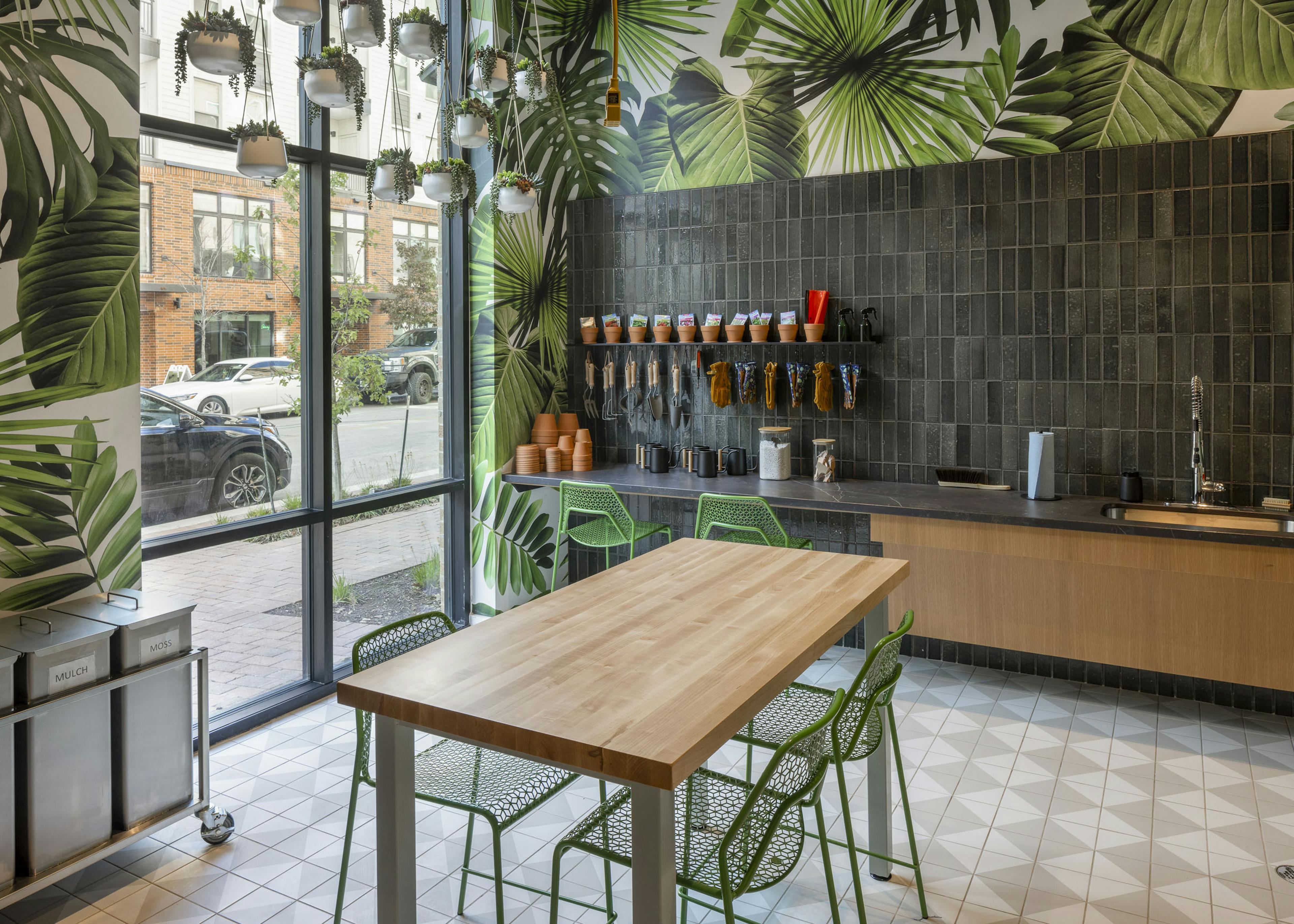 Garden room at AMLI Branch Park apartments featuring soil and mulch containers and a wide range of plant tools
