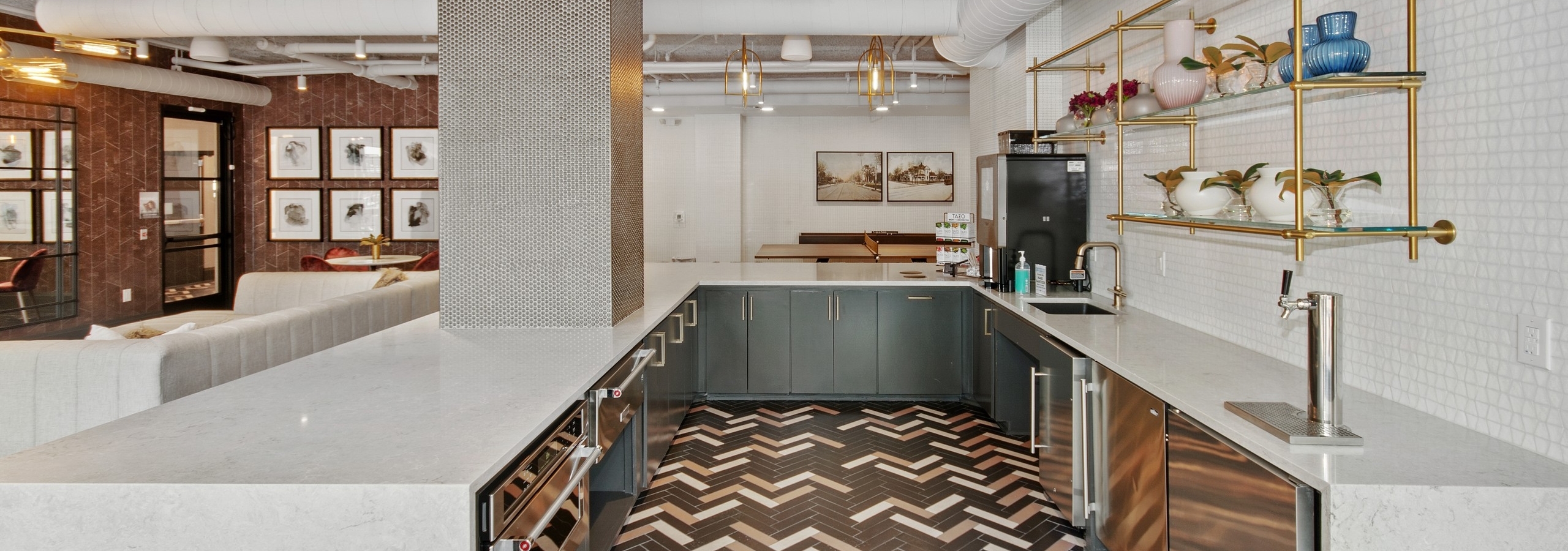 AMLI Quadrangle apartments resident kitchen equipped with Starbucks machine and stainless steel appliances on a tile floor