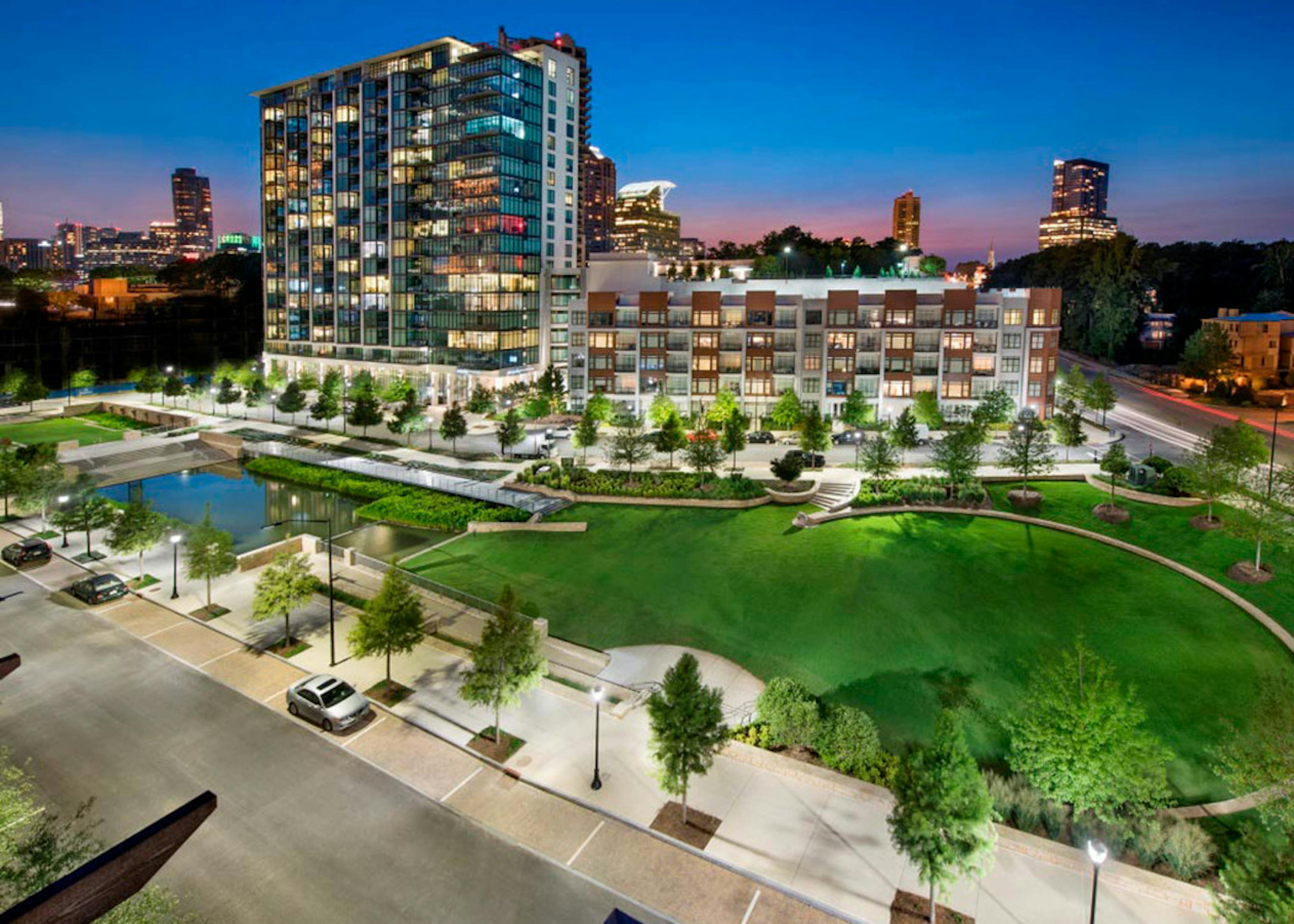 Nighttime exterior image of AMLI 3464 apartment showcasing its building and its views of Buckhead skyline and Stone Mountain
