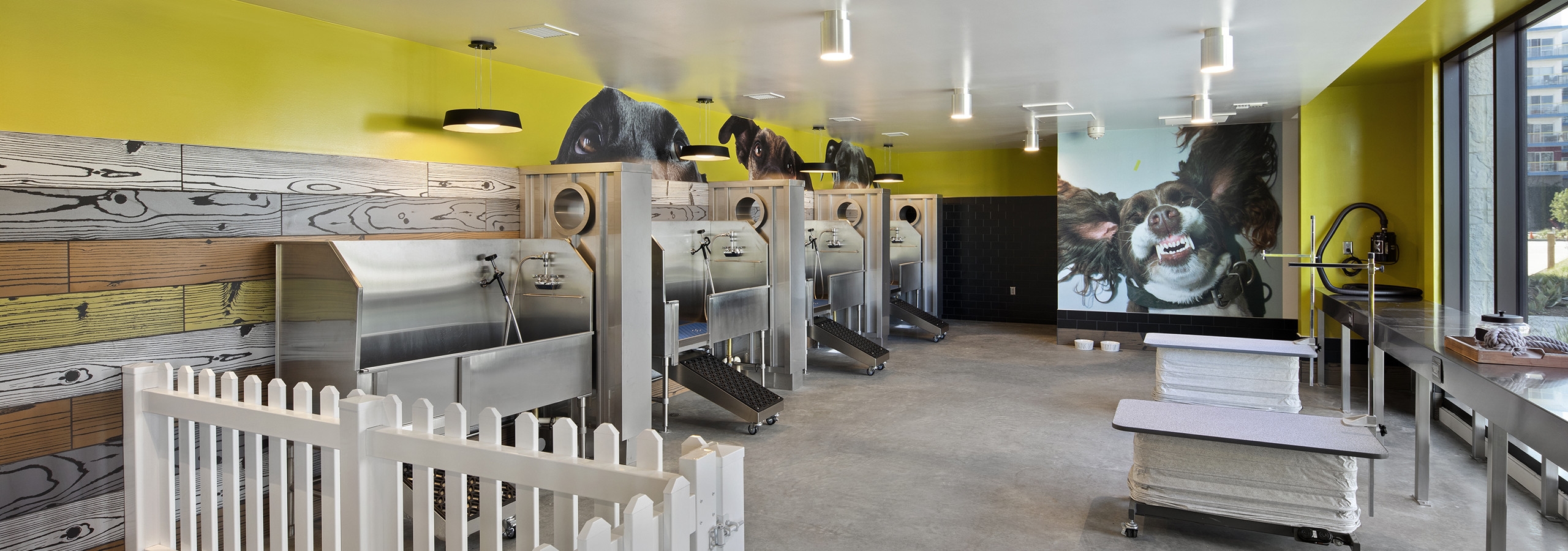 AMLI Marina Del Rey apartment pet spa at with four washing stations, two grooming tables and white picket fenced play area