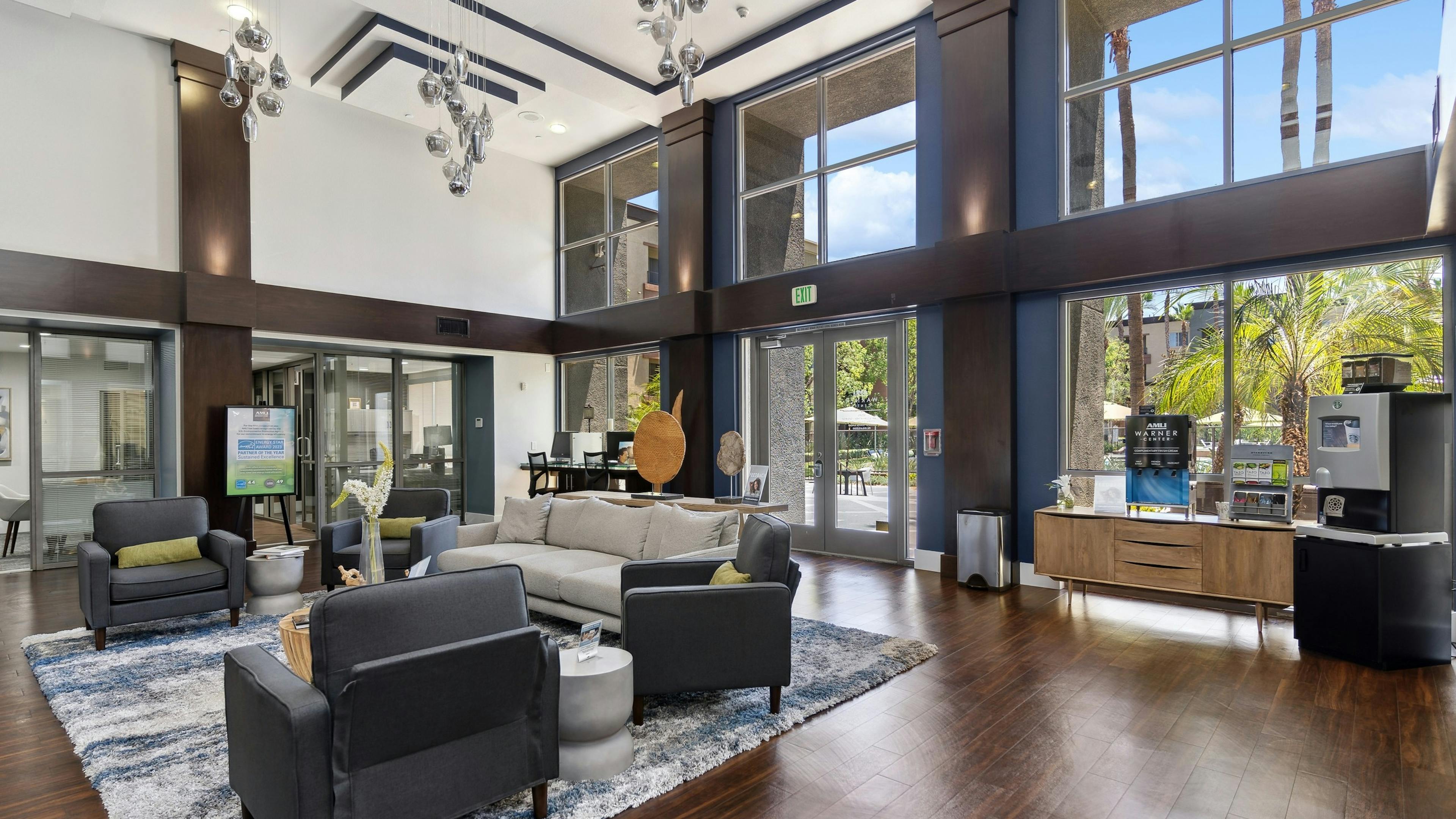AMLI Warner Center clubhouse with stylish seating area and open to leasing office with large windows facing the courtyard