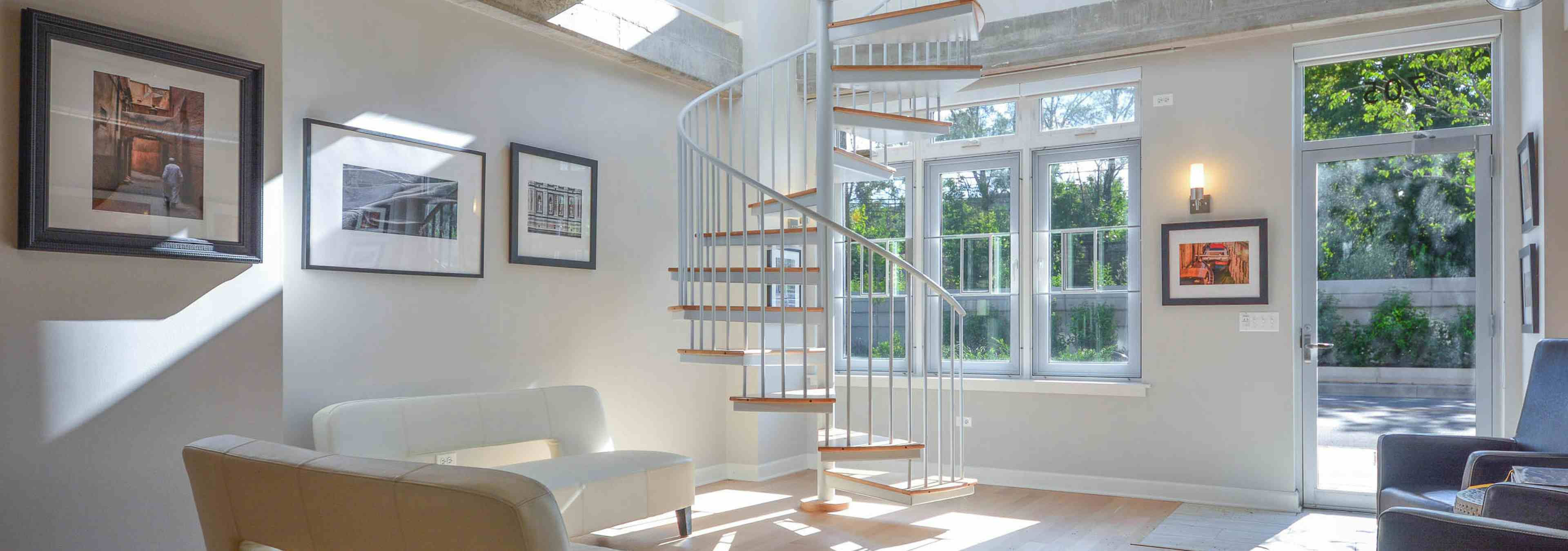 AMLI Evanston live work interior with light colored walls and wood floors featuring windows and glass doors leading outside